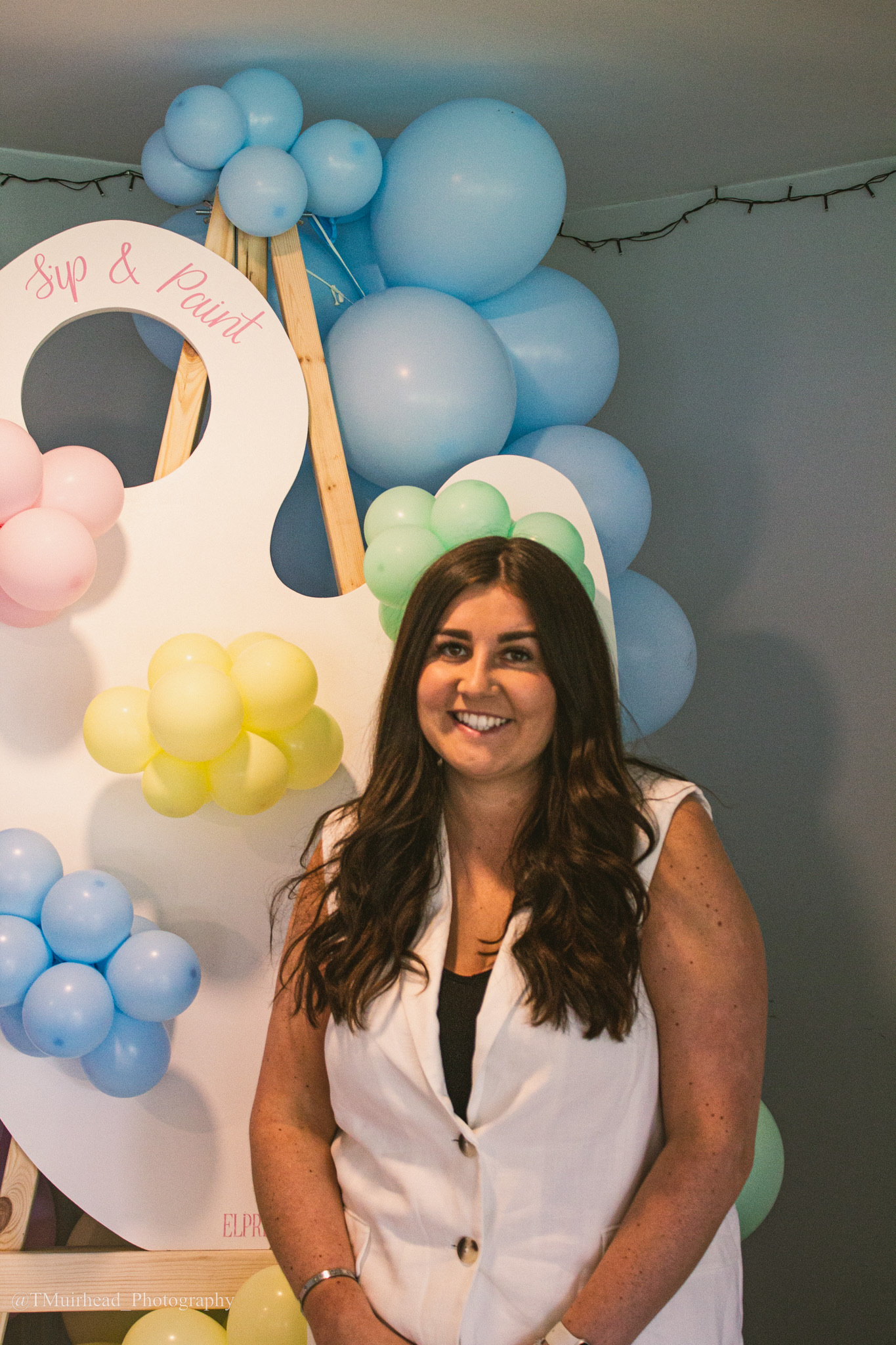 Founder Emma in front of a Balloon display